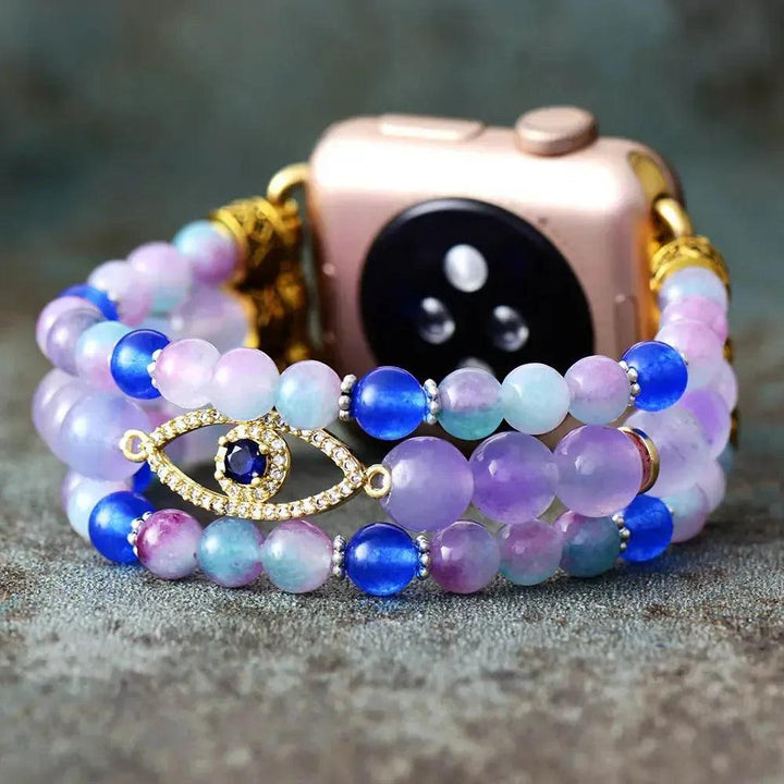 Fluorite Evil Eye Apple iWatch Band with vibrant purple, green, and blue beads, zircon evil eye charm, and gold accents.