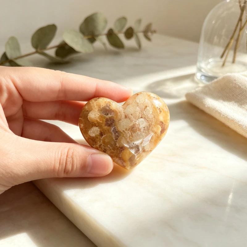 Polished Fossilized Coral Jade crystal heart with warm cream and terracotta patterns for heart chakra healing.