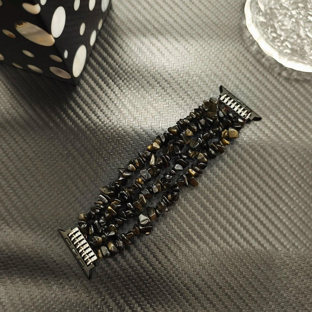 Four-row Black Agate crystal Apple Watch band featuring protective natural stone beads for a bold, layered look.