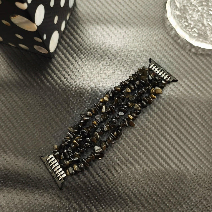 Four-row Black Agate crystal Apple Watch band featuring protective natural stone beads for a bold, layered look.