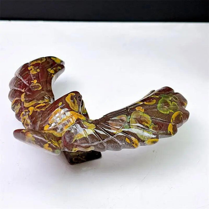 Fruit Jasper crystal eagle and pyramid spinning statue with unique, grounding earth-toned patterns for stability.