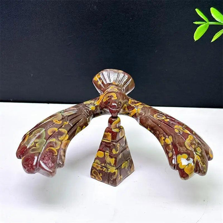 Fruit Jasper crystal eagle and pyramid spinning statue with unique red and yellow patterns for grounding and stability.