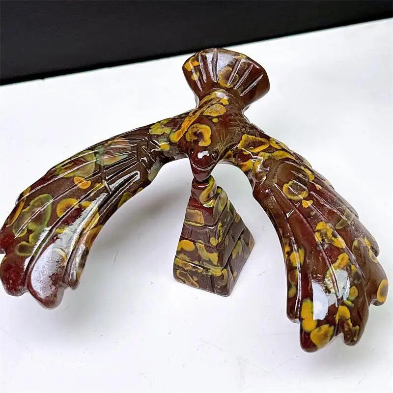 Fruit Jasper crystal eagle and pyramid spinning statue with unique brown and yellow patterns for grounding and stability.
