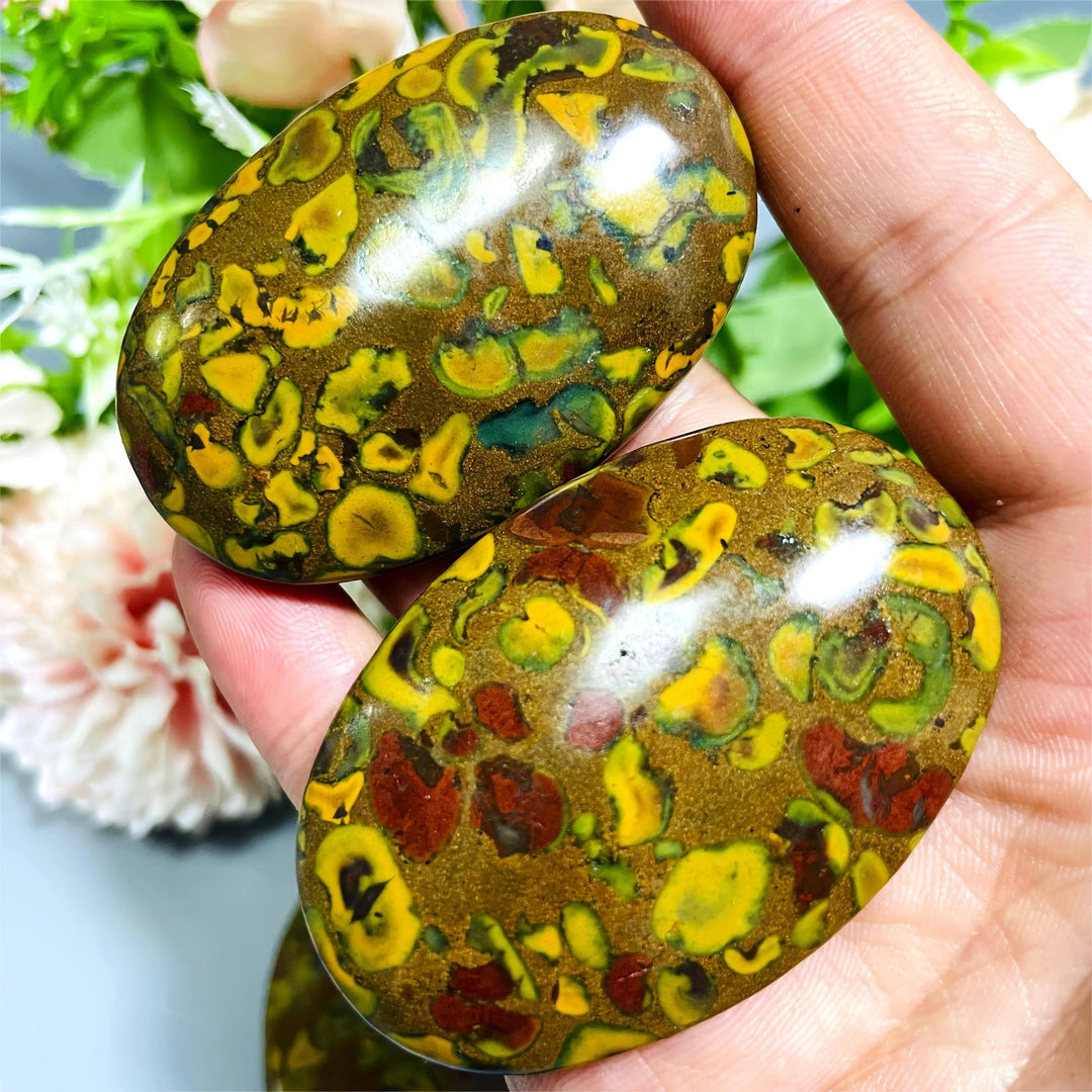 Polished Fruit Jasper Crystal Palm Stones with vibrant green, yellow, and red patterns for grounding.