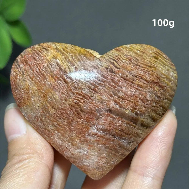 100g heart-shaped Thousand-Layer crystal ornament with natural red and brown banded patterns for healing and Feng Shui.