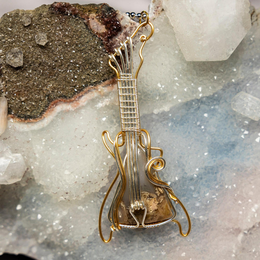 Garden Quartz Guitar Wire Wrap Pendant, 3.5-inch copper and silver wire-wrapped crystal promoting growth and balance.