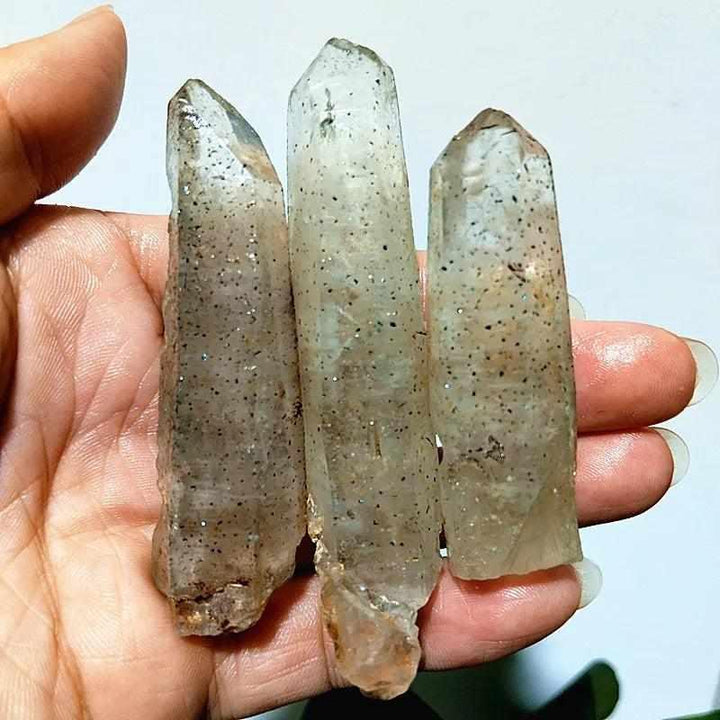 Polished Garden and Strawberry Quartz crystal points featuring mossy green inclusions and red flecks for heart chakra healing.