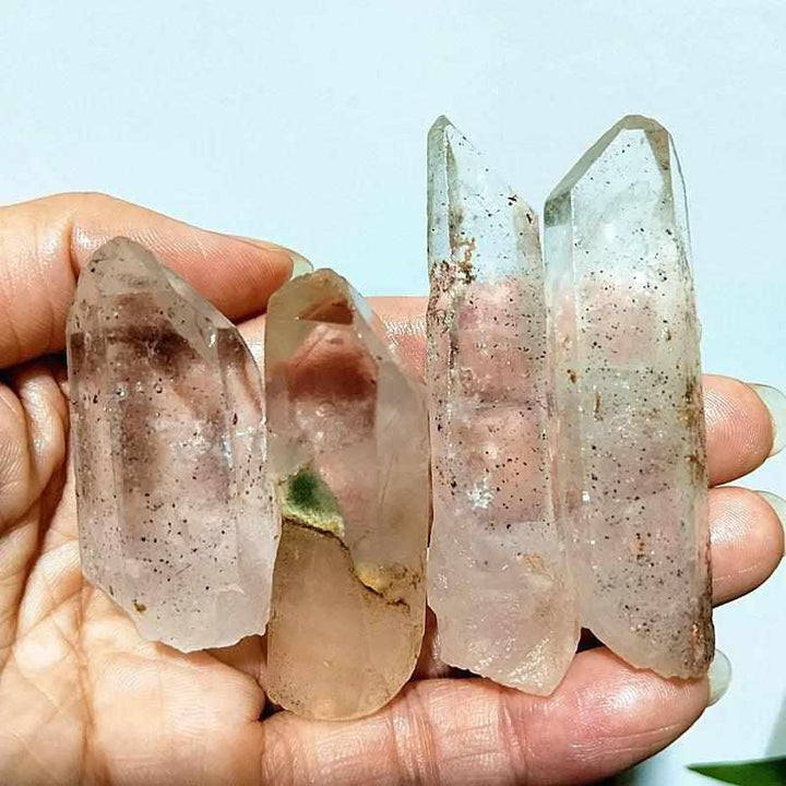 Polished Garden and Strawberry Quartz crystal points featuring mossy green inclusions and red flecks for heart chakra healing.