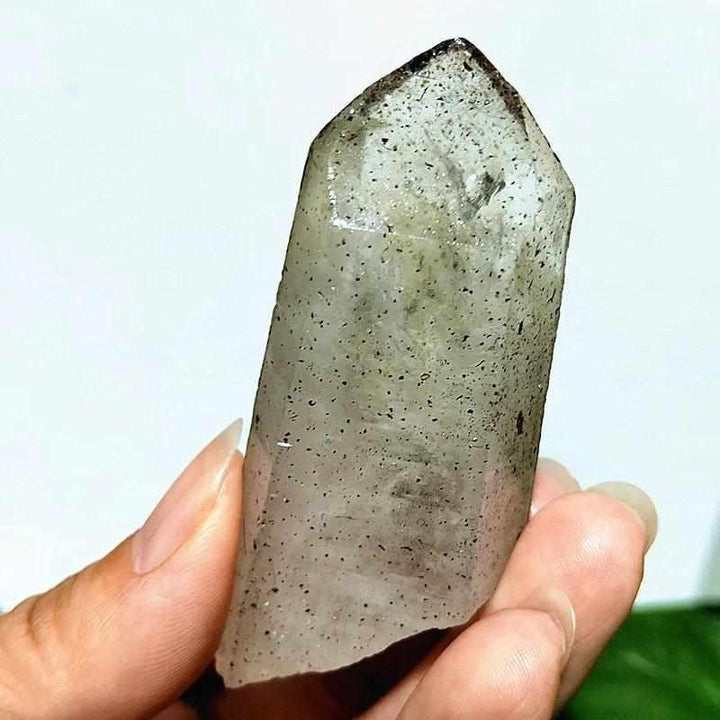 Polished Garden and Strawberry Quartz point featuring mossy green inclusions and red flecks for heart and root chakra healing.