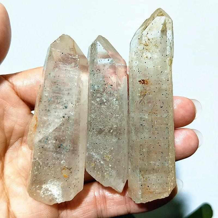 Polished Garden and Strawberry Quartz crystal towers featuring mossy green inclusions and red flecks for heart chakra healing.