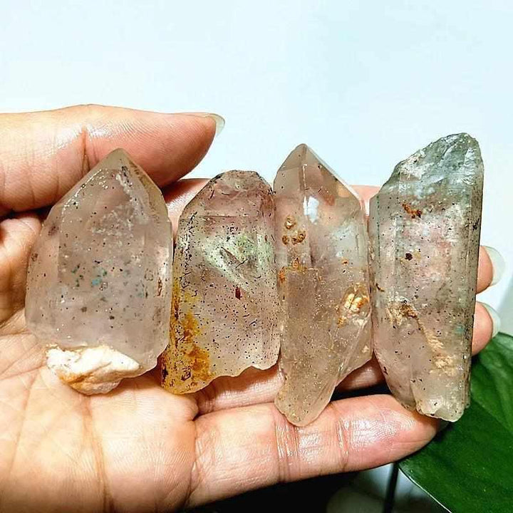 Polished Garden and Strawberry Quartz crystal points featuring mossy green landscapes and red flecks for heart chakra healing.