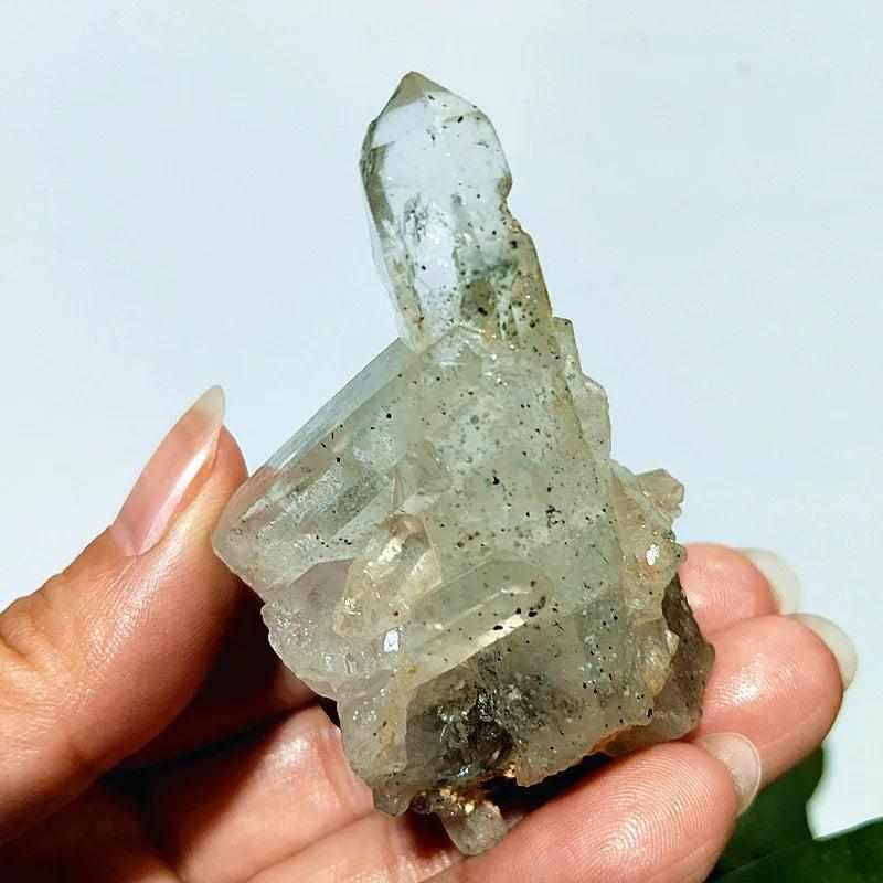 Polished Garden and Strawberry Quartz crystal point featuring mossy green inclusions and red flecks for heart chakra healing.