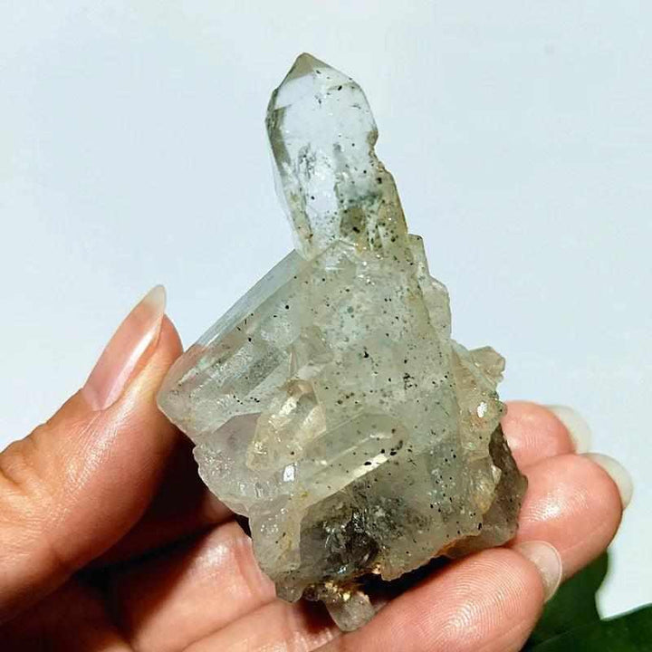 Polished Garden and Strawberry Quartz crystal point featuring mossy green inclusions and red flecks for heart chakra healing.