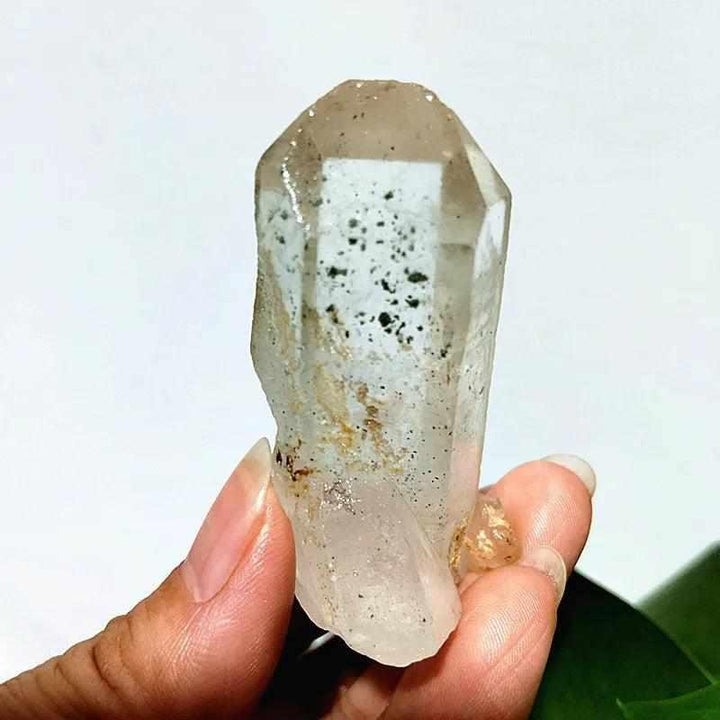 Polished Garden and Strawberry Quartz crystal point featuring mossy green inclusions and red flecks for heart chakra healing.