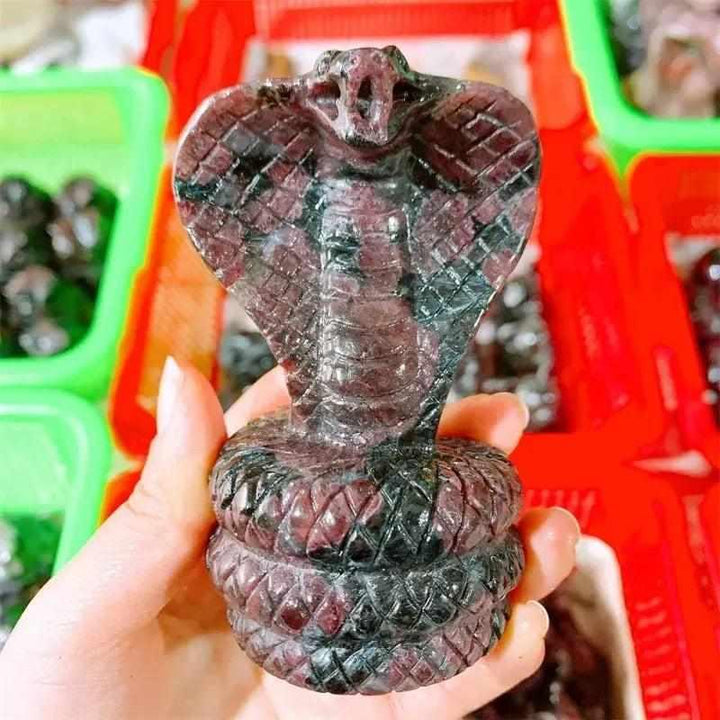 Hand-carved deep red garnet cobra snake sculpture, a powerful crystal for grounding, courage, and vitality.