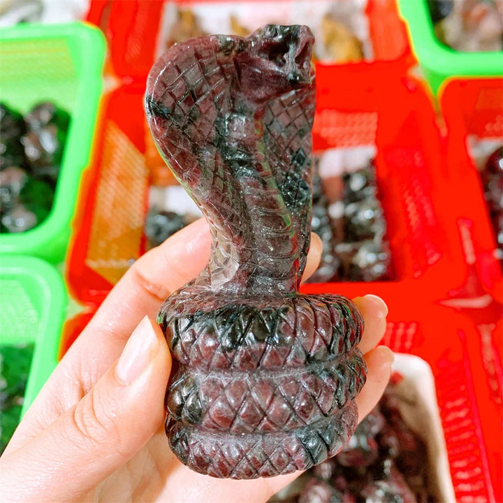 Deep red garnet crystal carved into a striking cobra, symbolizing courage and vitality for your altar or meditation space.