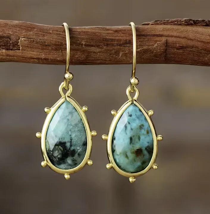Teardrop Amazonite gemstone earrings in gold settings, offering calming energy in a stylish, elegant drop design.