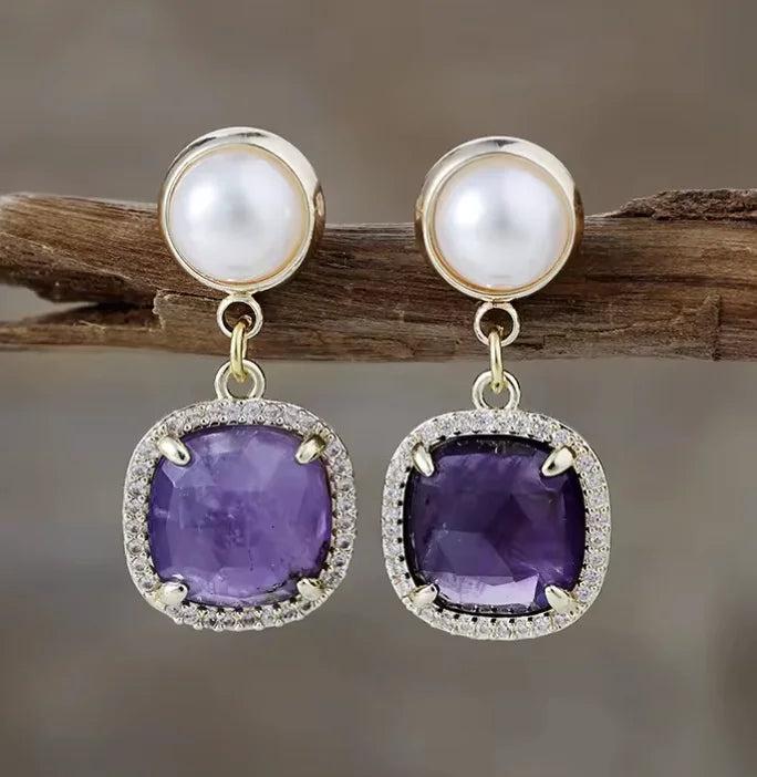 Amethyst drop earrings with pearl studs, featuring genuine purple gemstones in a sparkling halo setting for calm energy.