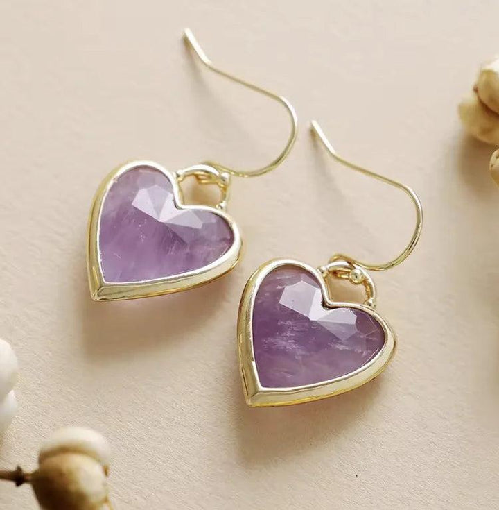 Amethyst heart-shaped drop earrings in gold settings, offering calming violet energy for your healing crystal collection.