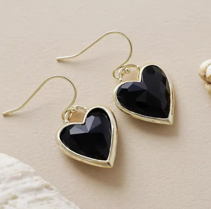 Black Onyx heart-shaped gemstone drop earrings in gold settings for grounding protection and elegant style.