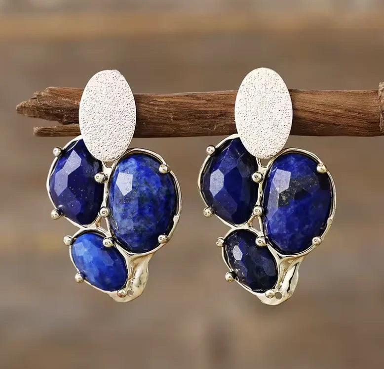 Lapis Lazuli Gemstone Crystal Earrings featuring deep blue faceted stones in a textured gold-tone drop design.