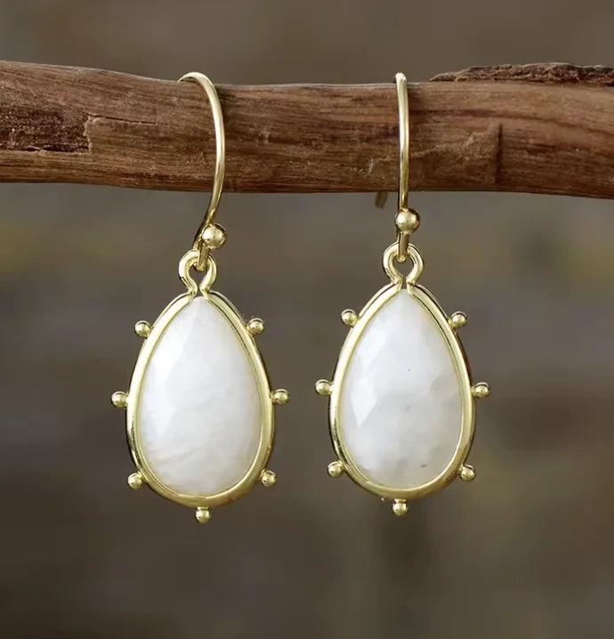 Moonstone drop earrings in gold setting, elegant gemstone crystal jewelry for intuition and healing energy.