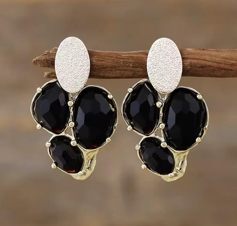 Black Onyx gemstone earrings featuring elegant gold-tone settings and textured studs for grounding energy.