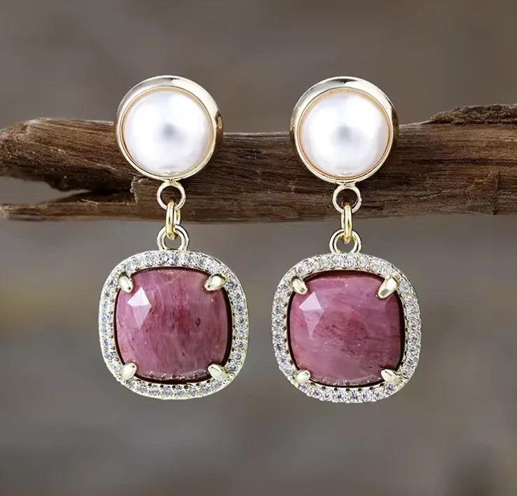 Rhodonite gemstone drop earrings with gold settings and pearl accents, perfect for balancing heart chakra energy.