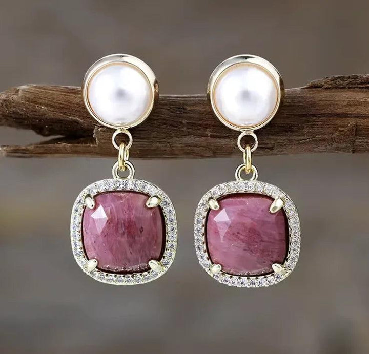 Rhodonite gemstone drop earrings with gold settings and pearl accents, perfect for balancing heart chakra energy.