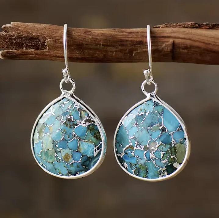 Teardrop African Turquoise gemstone earrings in silver settings, offering vibrant healing energy in a stylish drop design.