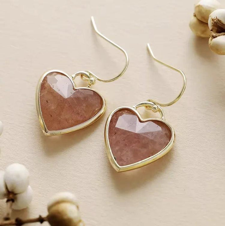 Faceted heart-shaped Strawberry Quartz gemstone earrings in gold settings for love and healing energy.