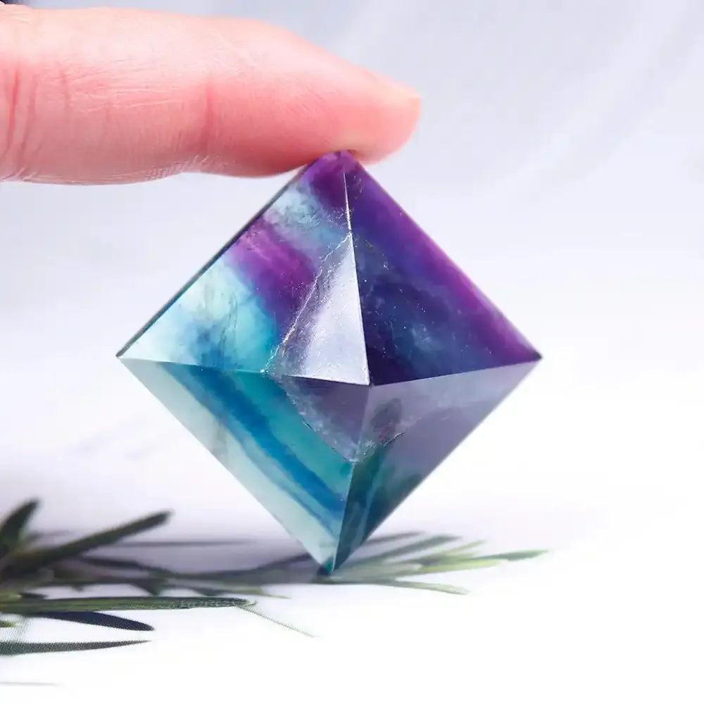 Polished rainbow fluorite mini pyramid crystal with vibrant purple and teal hues for focused energy and chakra healing.