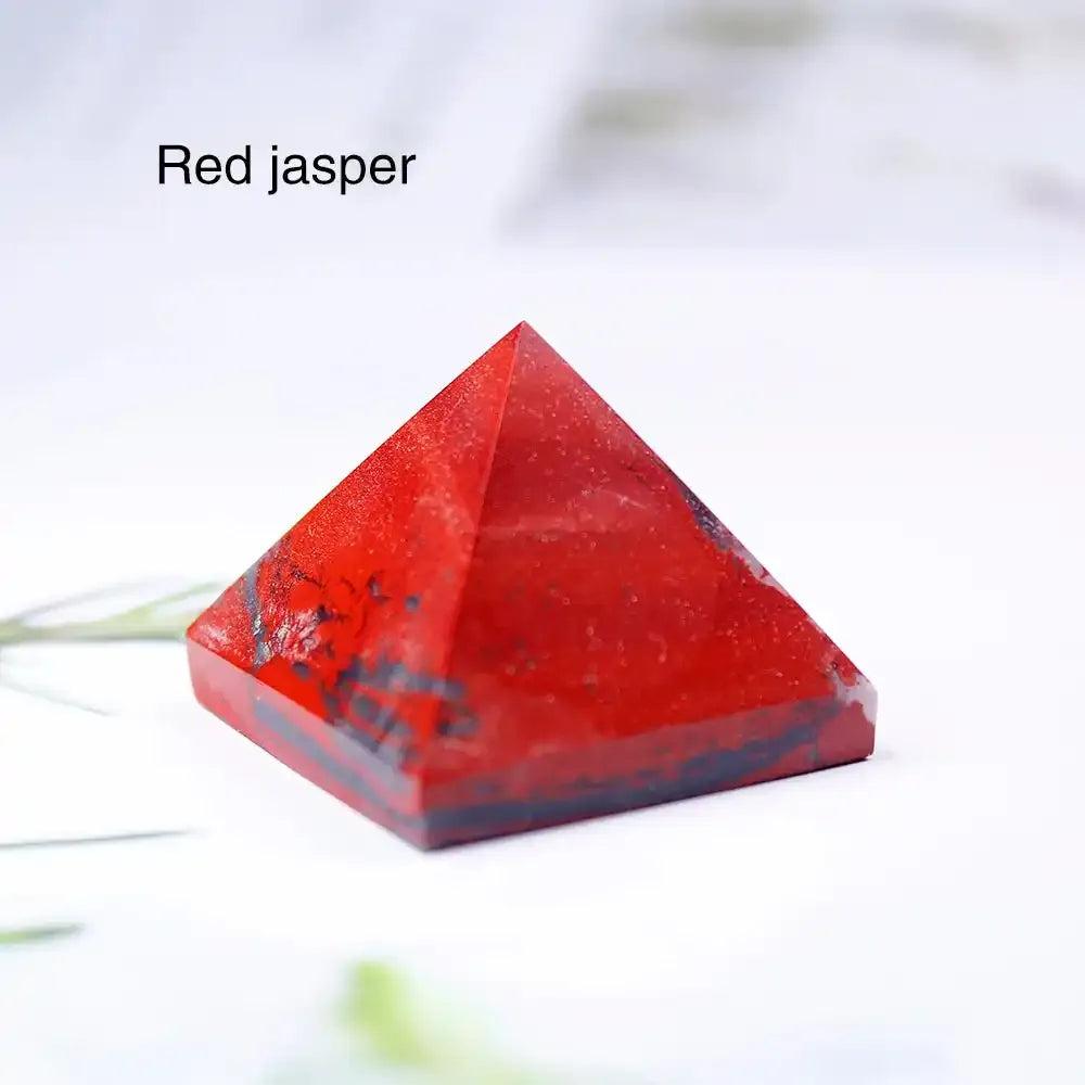 Polished red jasper mini gemstone pyramid, a 30mm sacred geometry crystal for root chakra grounding and intention setting.