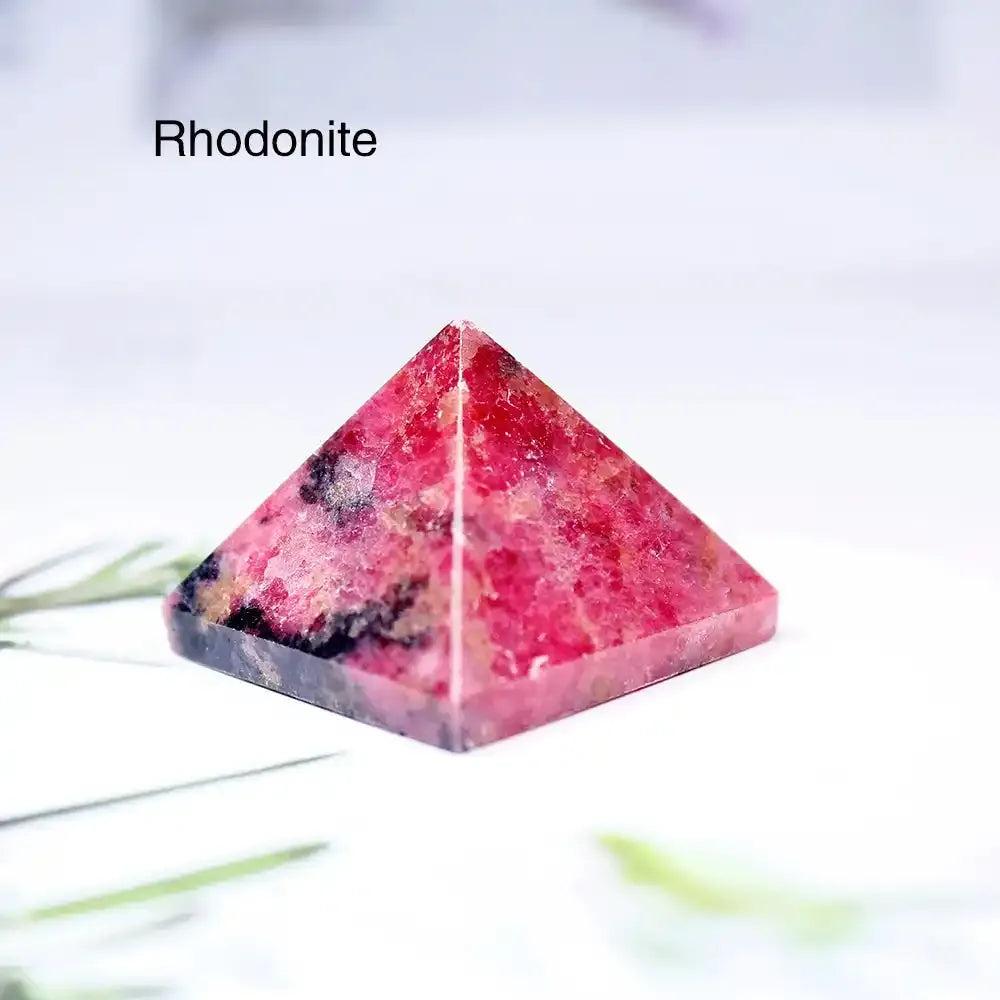 Polished Rhodonite gemstone mini pyramid, a 30mm sacred geometry crystal for focused intention and heart chakra healing.