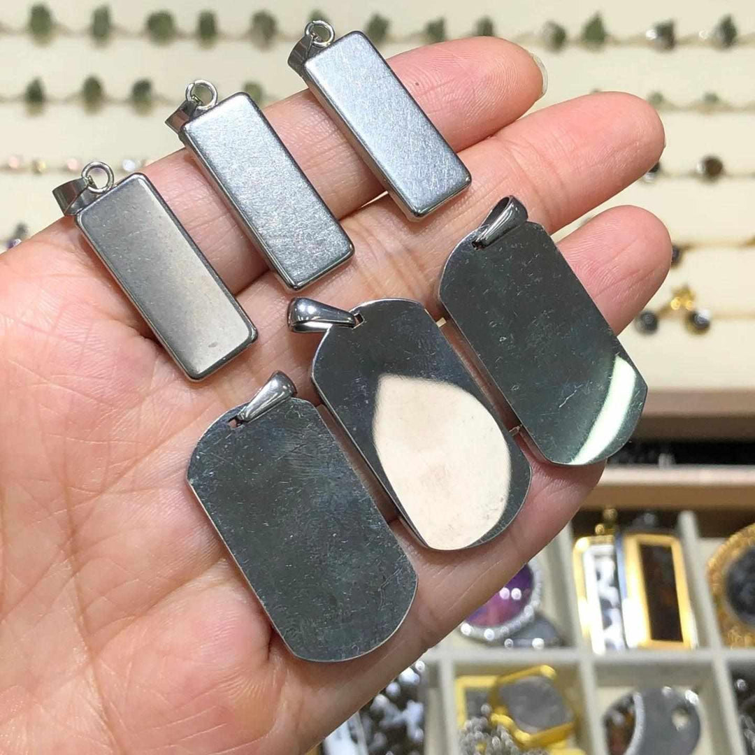 Gibeon meteorite crystal necklace pendants in stainless steel rectangle frames, featuring unique cosmic iron patterns.