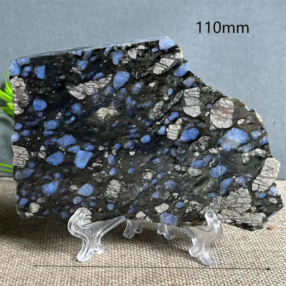 Glaucophane slab from Crystal Destiny, a natural blue-gray crystal specimen on a clear stand, 110mm wide.