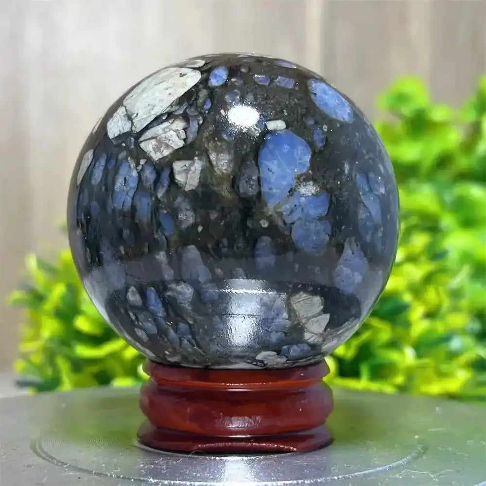 Polished Glaucophane sphere with blue and grey mineral inclusions, perfect for Reiki healing and spiritual home decor.