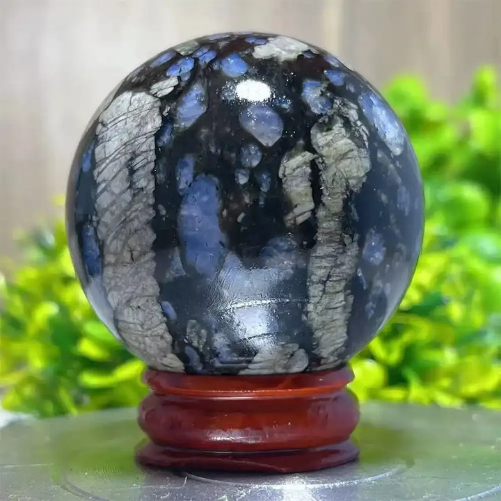Polished Glaucophane sphere with blue and grey mineral inclusions, perfect for Reiki healing and spiritual home decor.