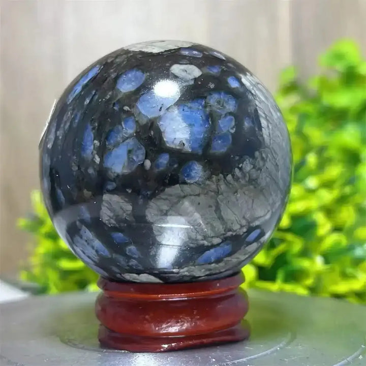 Polished Glaucophane sphere with vibrant blue and black patterns, perfect for Reiki healing and spiritual home decor.