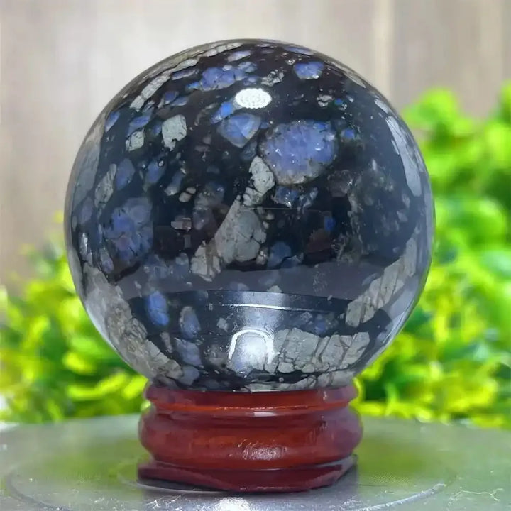 Polished Glaucophane sphere with deep blue and grey mineral inclusions, perfect for Reiki healing and spiritual home decor.