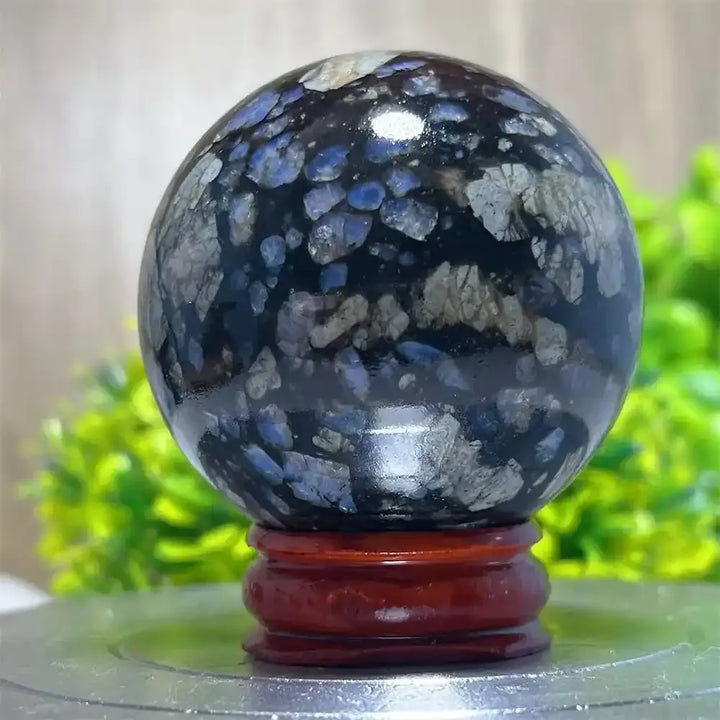 Polished Glaucophane sphere with blue and grey mineral inclusions, perfect for Reiki healing and spiritual home decor.