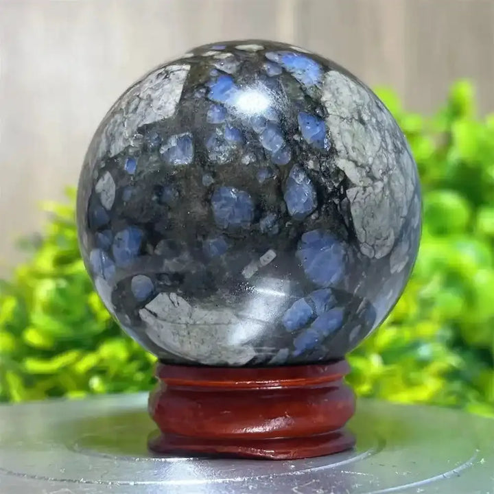 Polished Glaucophane sphere with striking blue and grey patterns, perfect for Reiki healing and spiritual home decor.