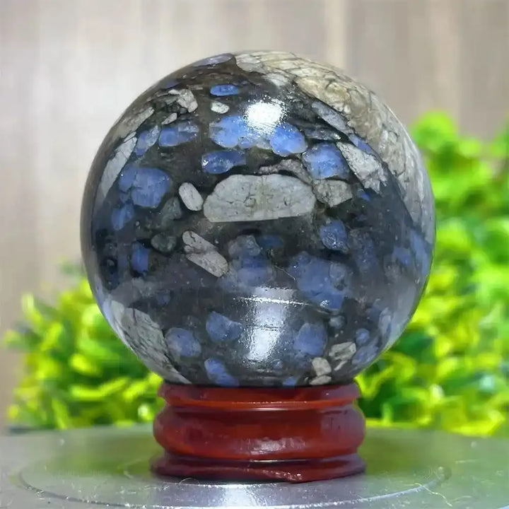 Polished Glaucophane Que Sera crystal sphere with blue and grey mineral inclusions, perfect for Reiki healing and decor.
