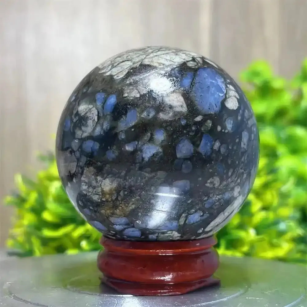 Polished Glaucophane sphere featuring blue and grey mineral inclusions, perfect for Reiki healing and spiritual home decor.