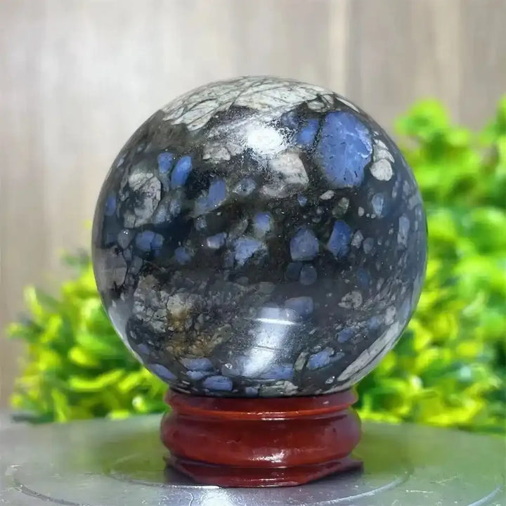 Polished Glaucophane sphere featuring blue and grey mineral inclusions, perfect for Reiki healing and spiritual home decor.
