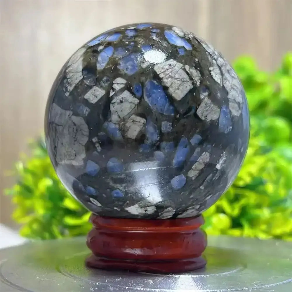 Polished Glaucophane sphere featuring blue and grey mineral inclusions, perfect for Reiki healing and spiritual home decor.