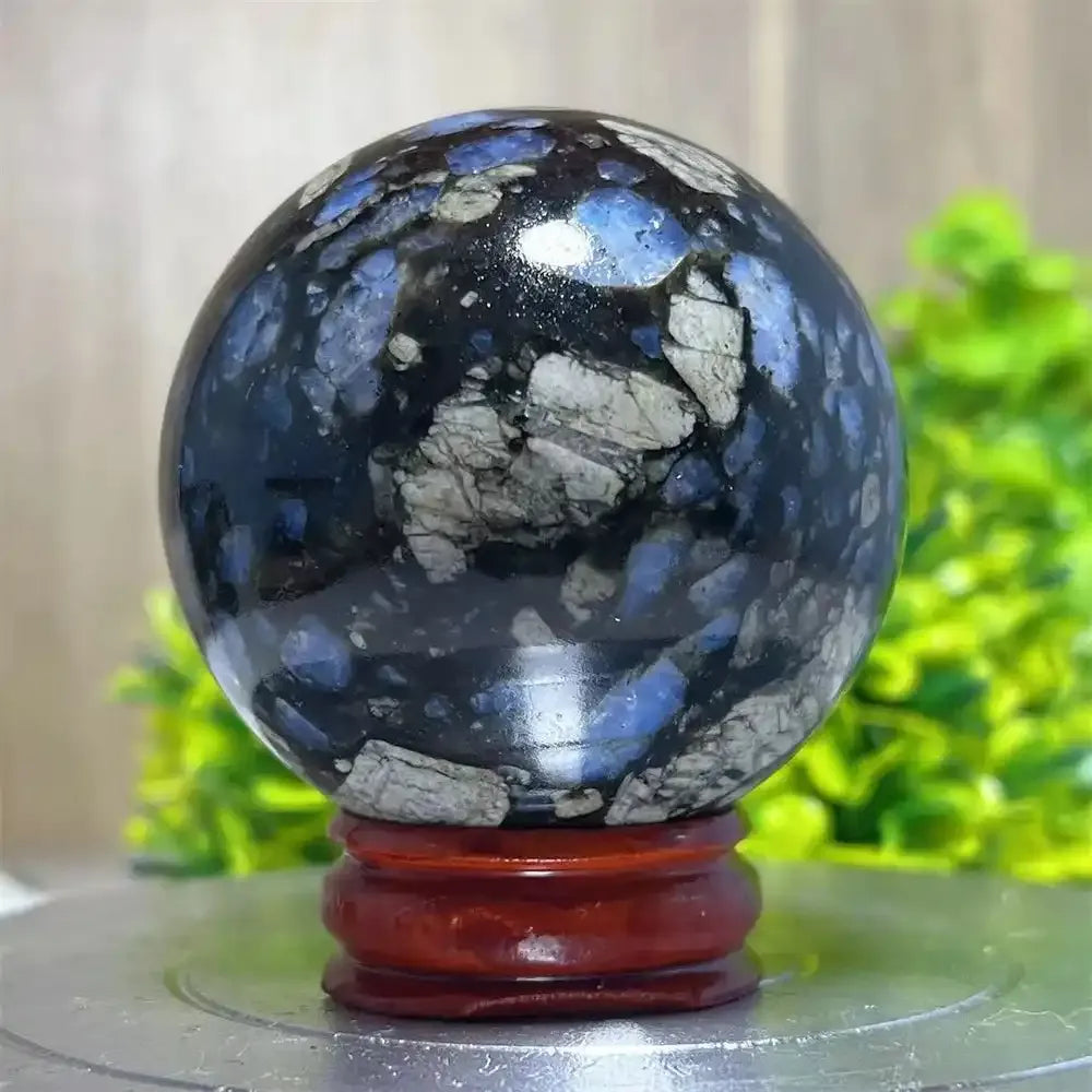 Polished Glaucophane sphere with blue and grey mineral inclusions, perfect for Reiki healing and spiritual home decor.
