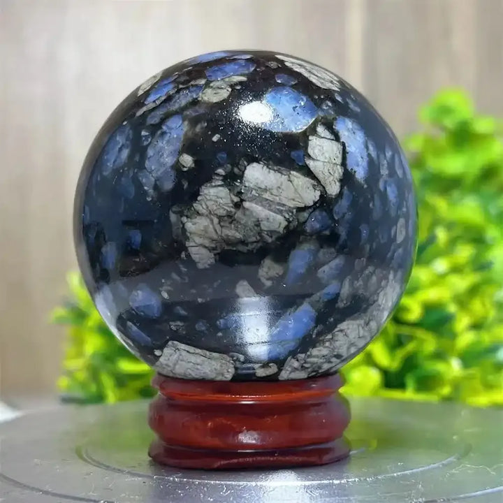 Polished Glaucophane sphere with blue and grey mineral inclusions, perfect for Reiki healing and spiritual home decor.