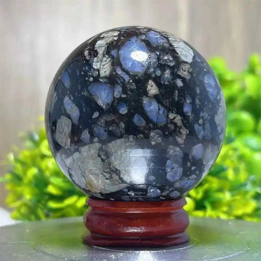Polished Glaucophane sphere featuring blue and black mineral patterns, perfect for Reiki healing and spiritual home decor.