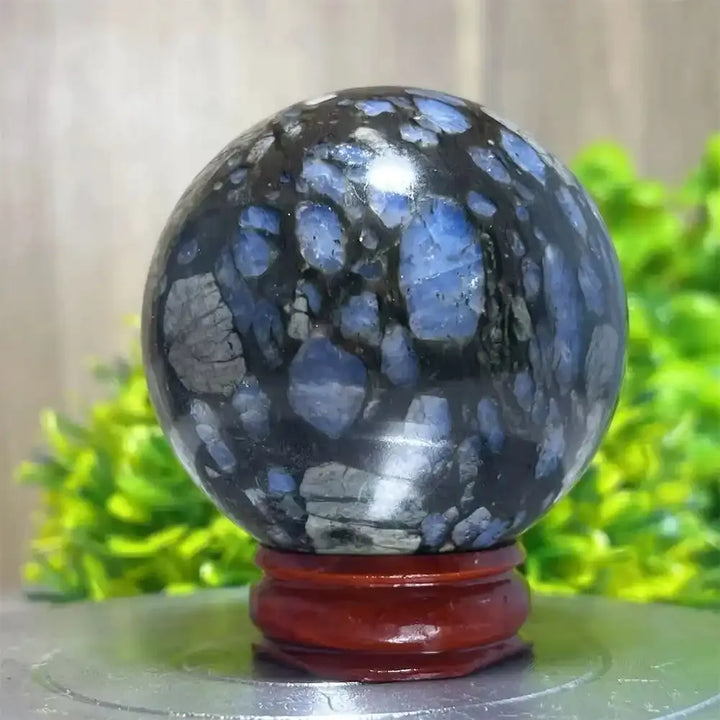 Polished Glaucophane sphere with striking blue and black patterns, perfect for Reiki healing and spiritual home decor.